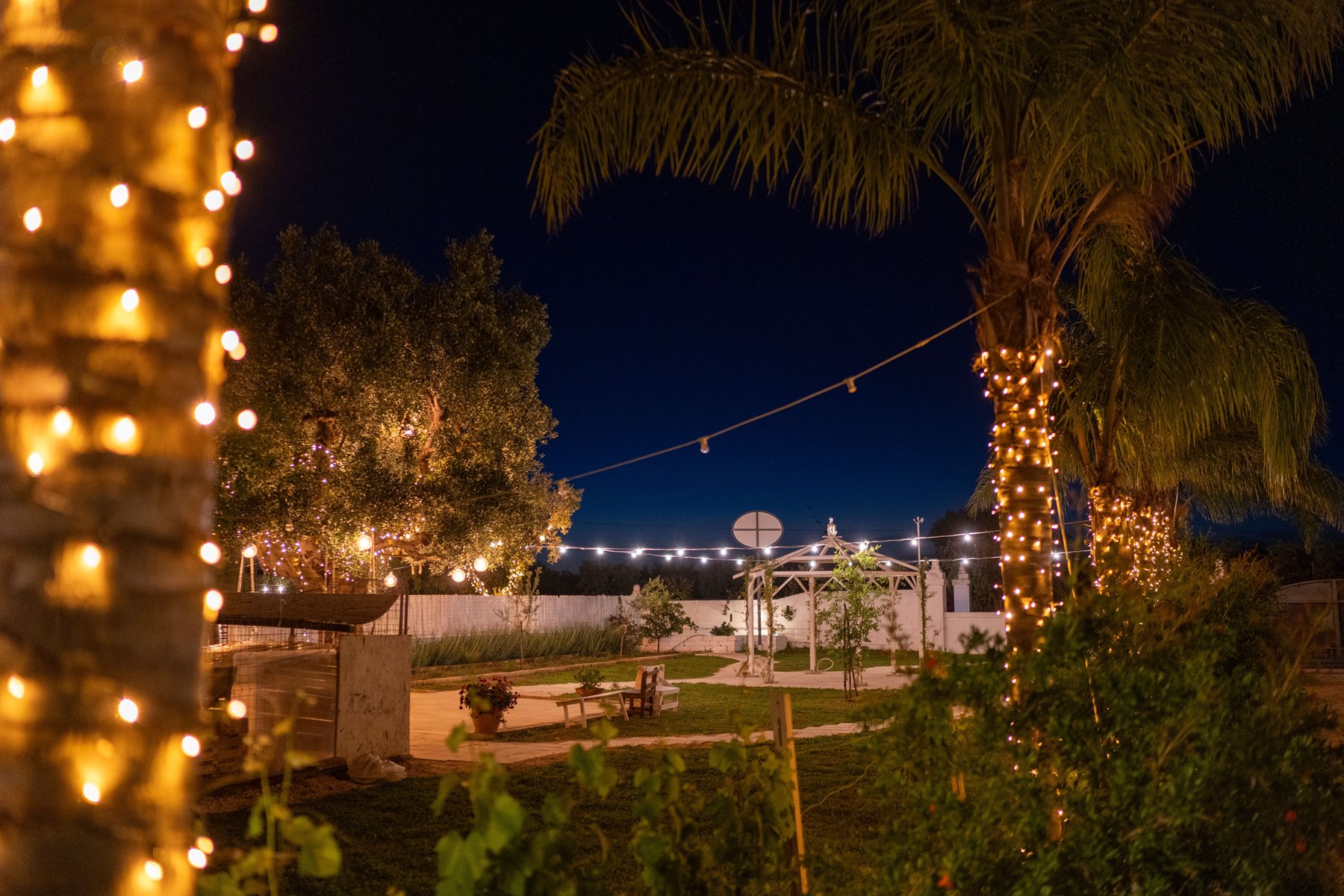 Il giardino della Masseria tra palme e luci serali
